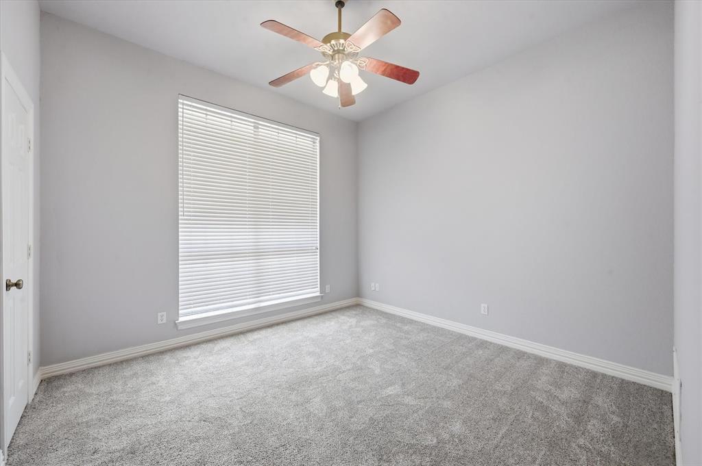 5513 Rustic Trail Colleyville, TX 76034 - Photo 23 of 40 an empty room with a window and a fan