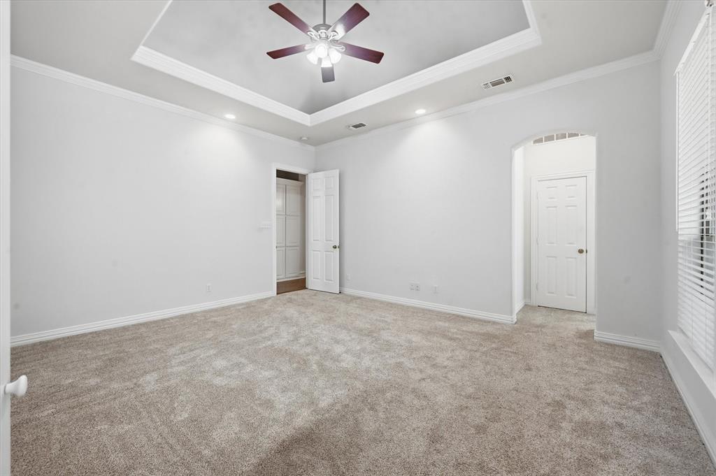 5513 Rustic Trail Colleyville, TX 76034 - Photo 27 of 40 an empty room with a ceiling fan and a window