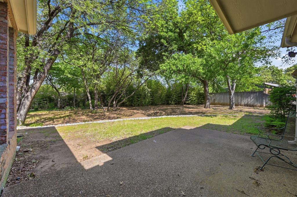 5513 Rustic Trail Colleyville, TX 76034 - Photo 32 of 40 a view of a swimming pool with a yard