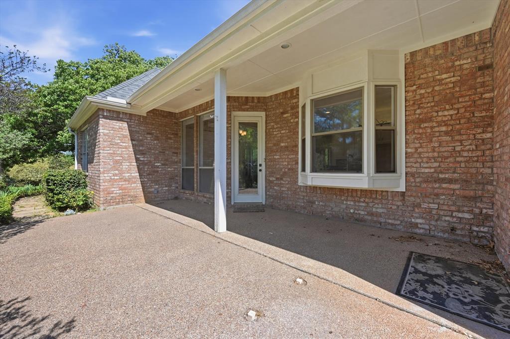 5513 Rustic Trail Colleyville, TX 76034 - Photo 33 of 40 a porch with seating space and yard in the back