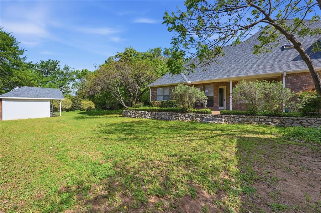 5513 Rustic Trail Colleyville, TX 76034 - Photo 34 of 40 a front view of house with yard and green space