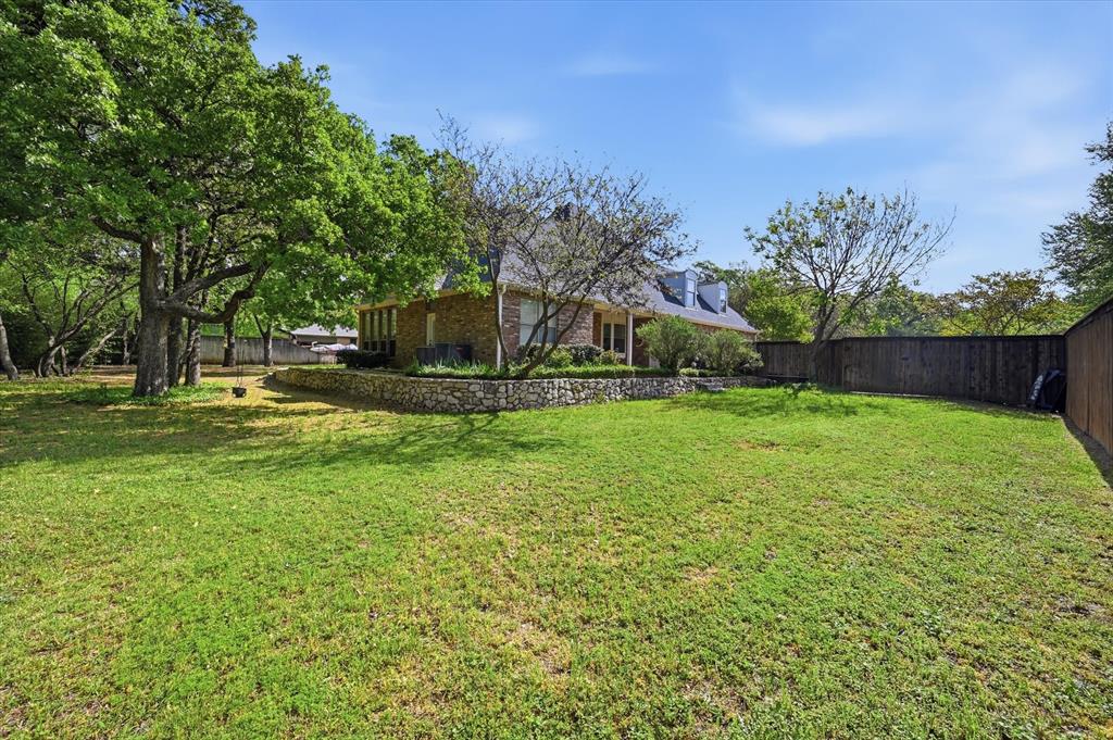 5513 Rustic Trail Colleyville, TX 76034 - Photo 35 of 40 a view of a backyard with a garden