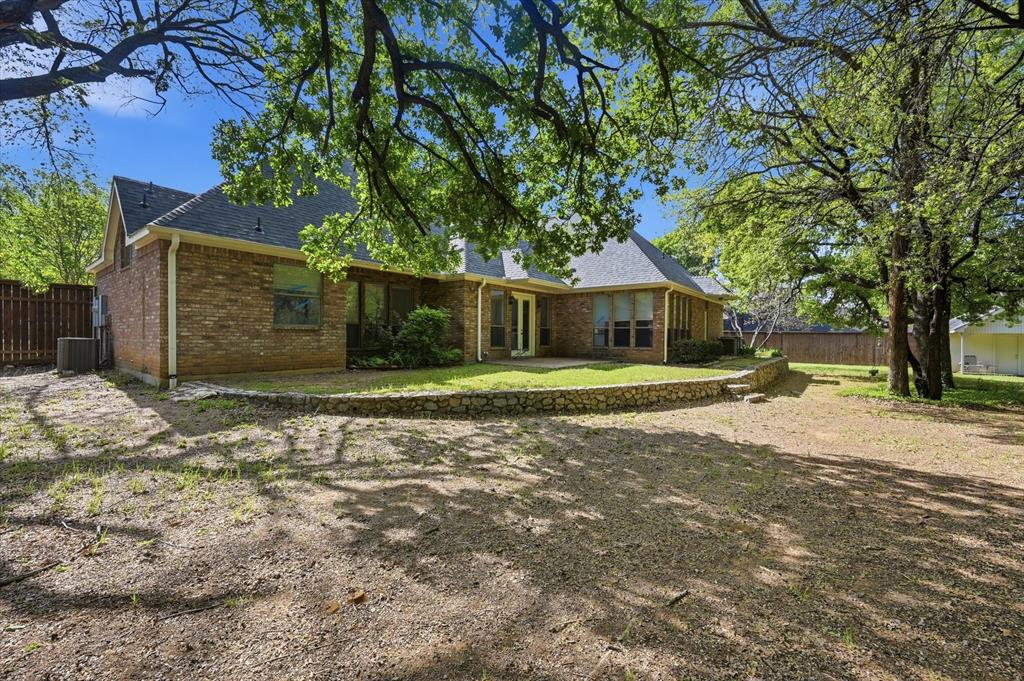 5513 Rustic Trail Colleyville, TX 76034 - Photo 37 of 40 a view of a house with a yard