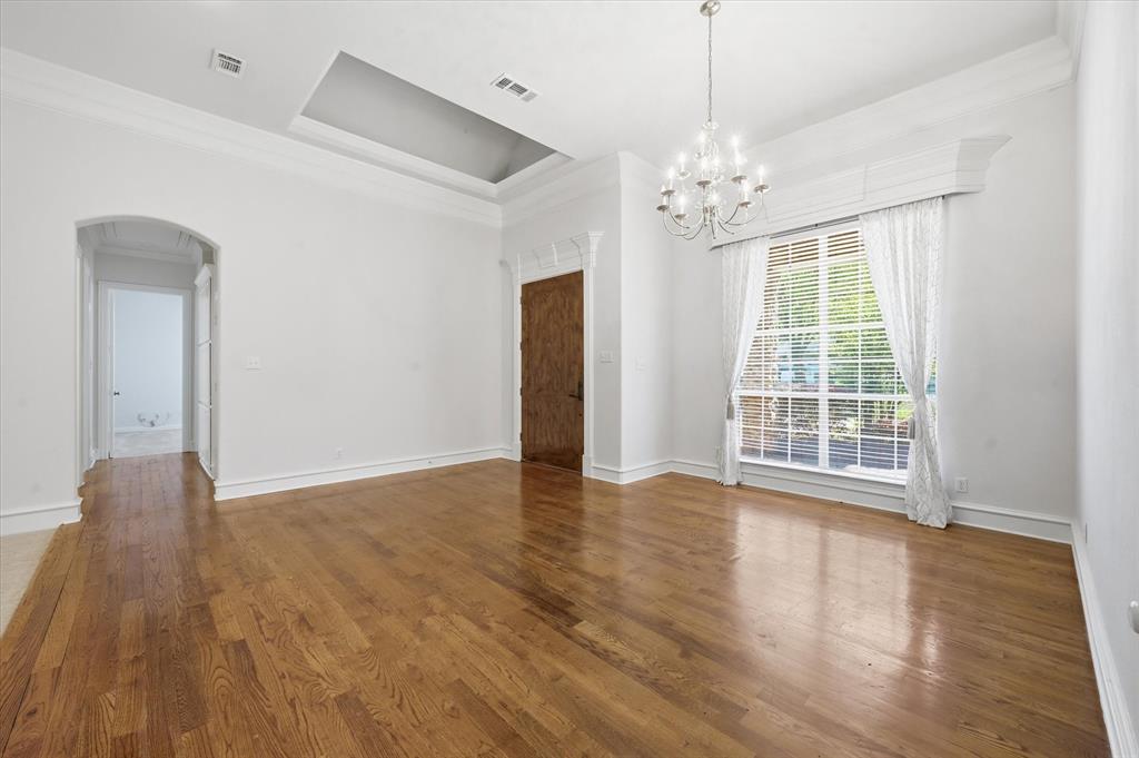 5513 Rustic Trail Colleyville, TX 76034 - Photo 5 of 40 a view of an empty room with wooden floor and a window
