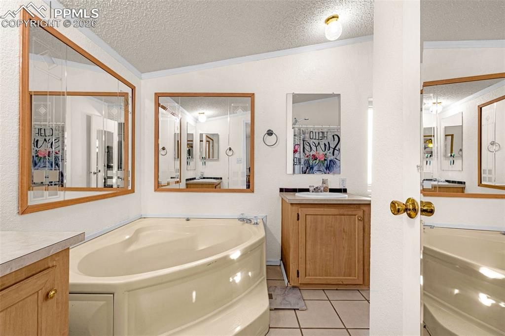 36925 Shear Road Yoder, CO 80864 - Photo 13 of 35 a spacious bathroom with a tub sink and mirror