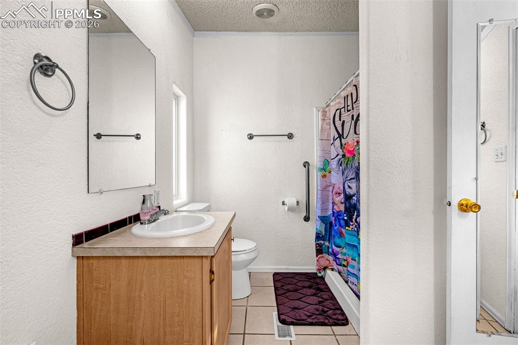 36925 Shear Road Yoder, CO 80864 - Photo 15 of 35 a bathroom with a granite countertop sink and a mirror