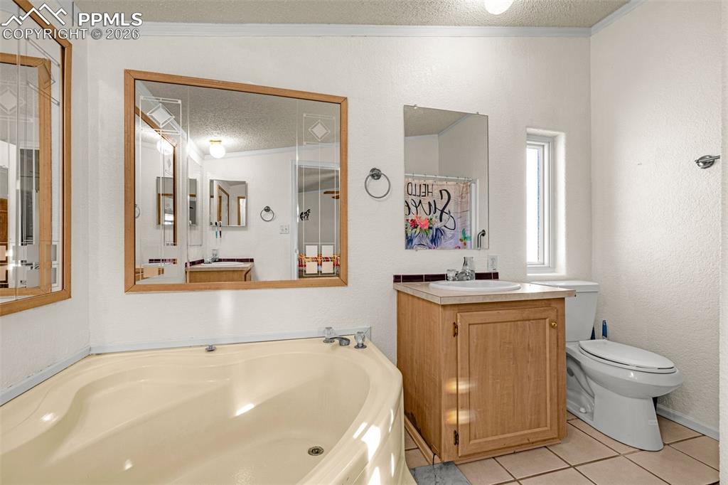 36925 Shear Road Yoder, CO 80864 - Photo 16 of 35 a bathroom with a sink a toilet and mirror