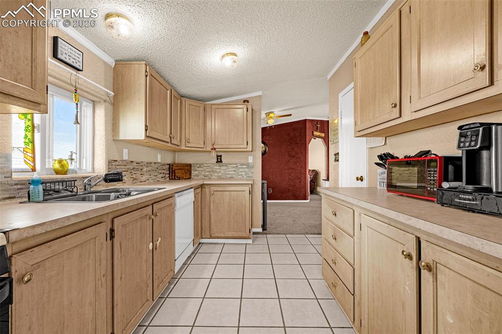 36925 Shear Road Yoder, CO 80864 - Photo 7 of 35 a kitchen with a sink a refrigerator and cabinets