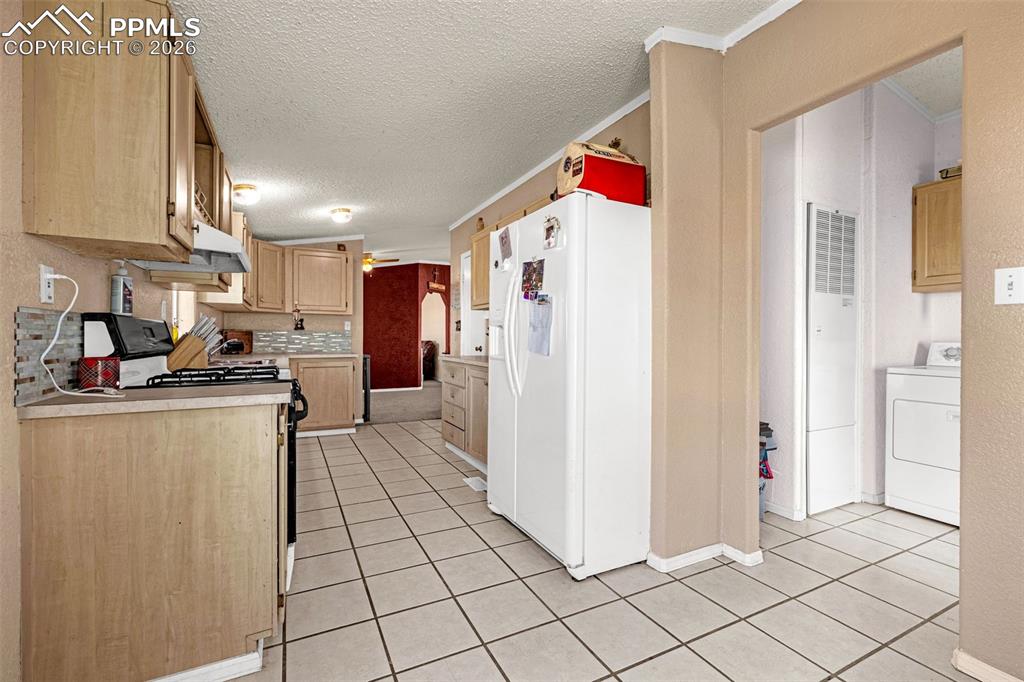 36925 Shear Road Yoder, CO 80864 - Photo 8 of 35 a kitchen with refrigerator and white cabinets