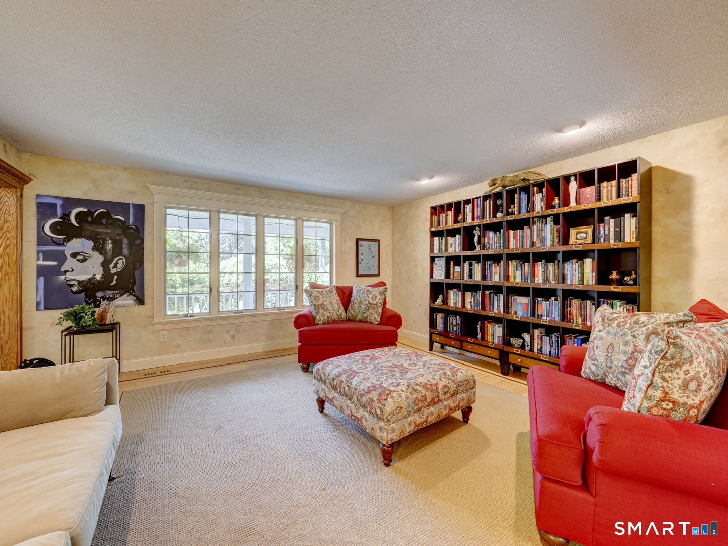 13 Executive Hill Road Wolcott, CT 06716 - Photo 7 of 40 a living room with furniture and a book shelf
