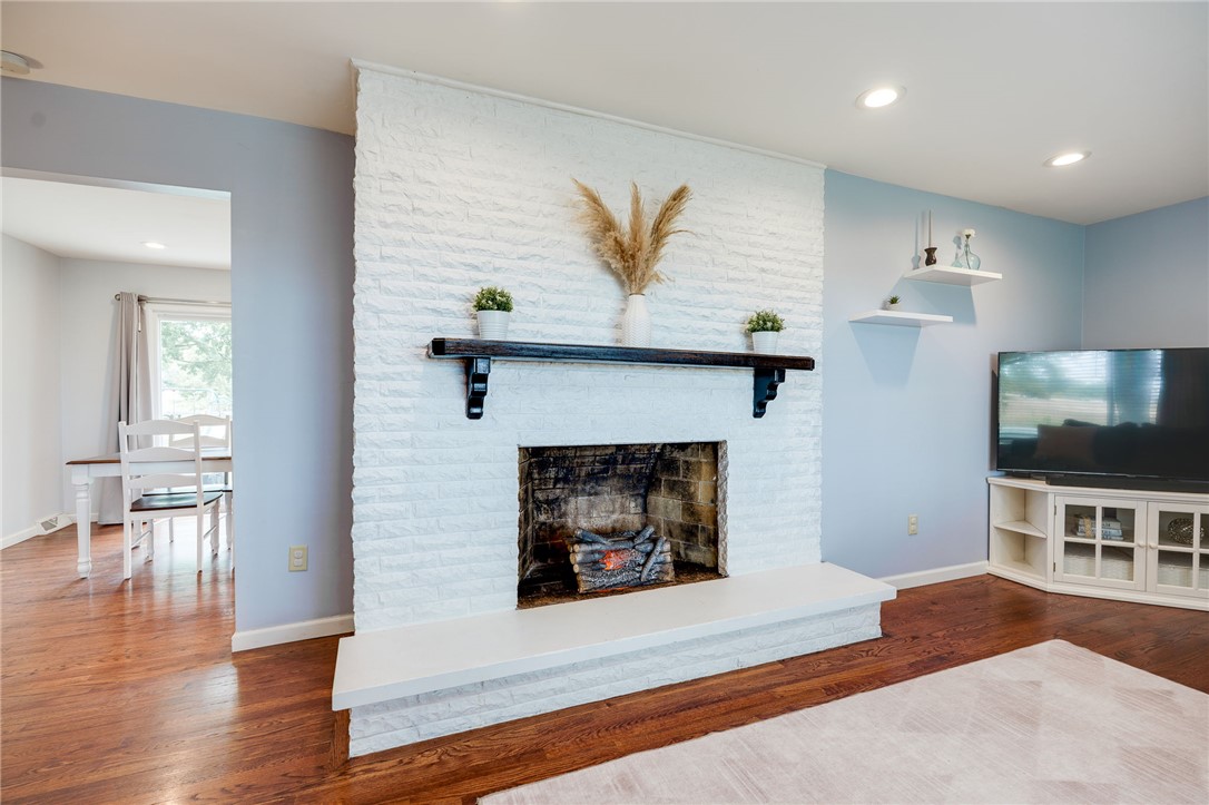6950 Red Lion 5 Points Road Springboro, OH 45066 - Photo 12 of 78 This inviting living space features rich hardwood flooring and a charming brick fireplace.