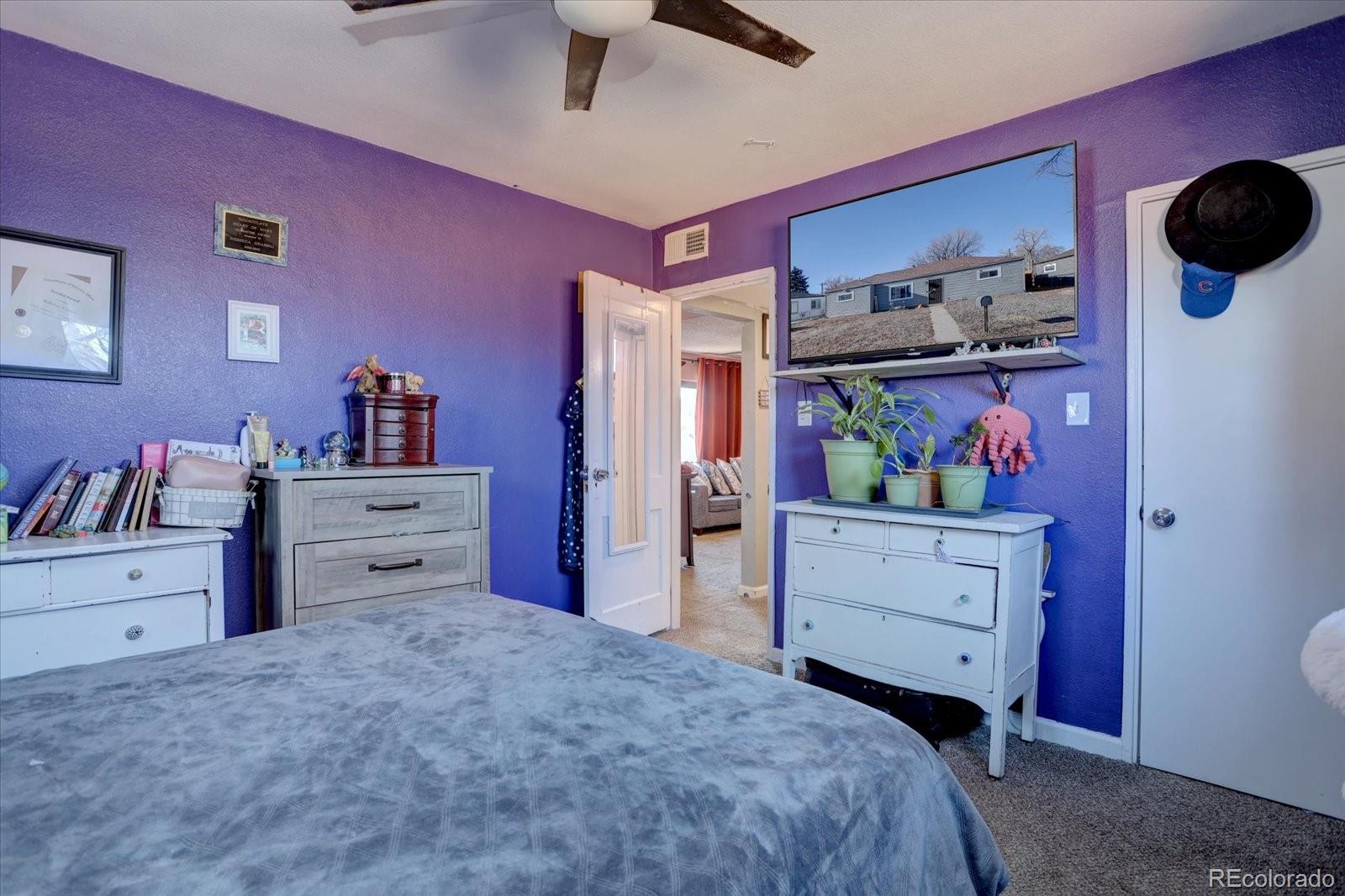 775 Victor Street Aurora, CO 80011 - Photo 11 of 21 a bed room with a bed and a television