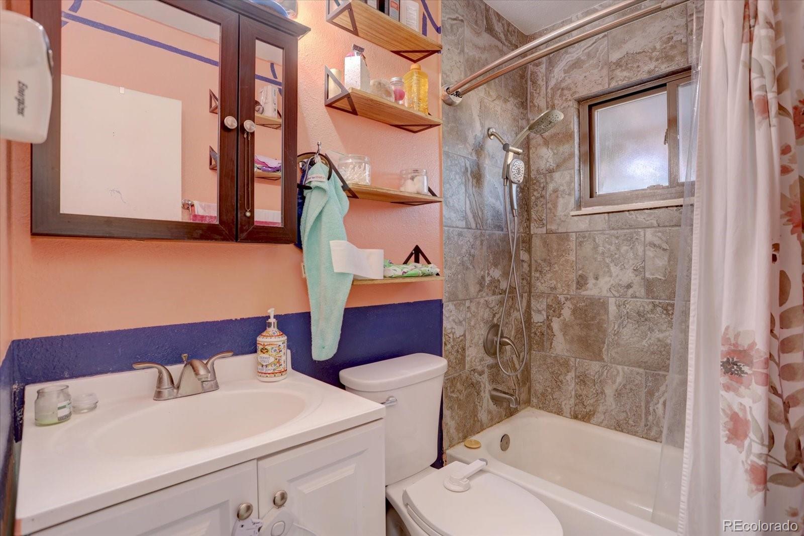 775 Victor Street Aurora, CO 80011 - Photo 12 of 21 a bathroom with a sink and a mirror