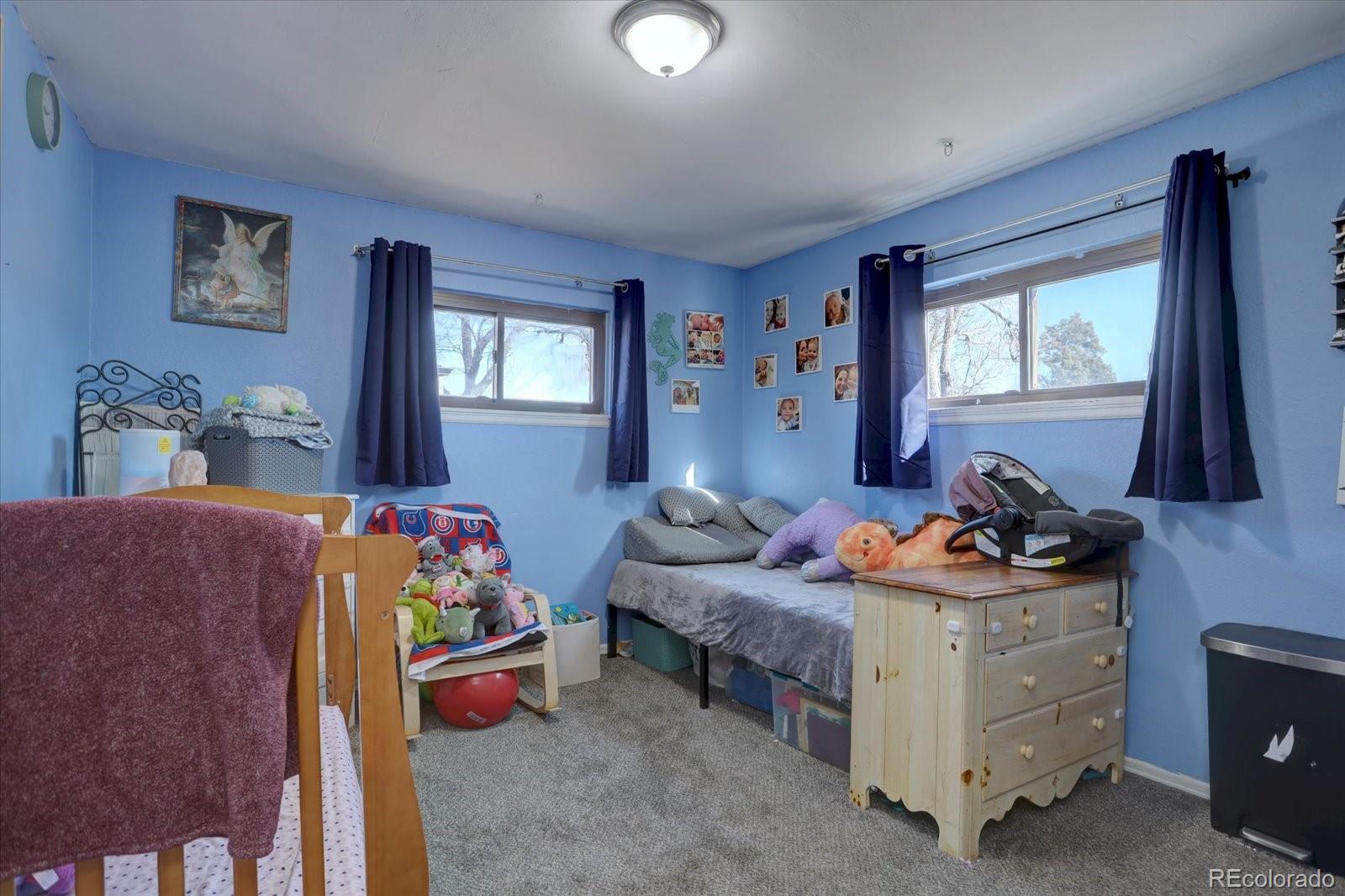 775 Victor Street Aurora, CO 80011 - Photo 13 of 21 a bedroom with furniture and a window