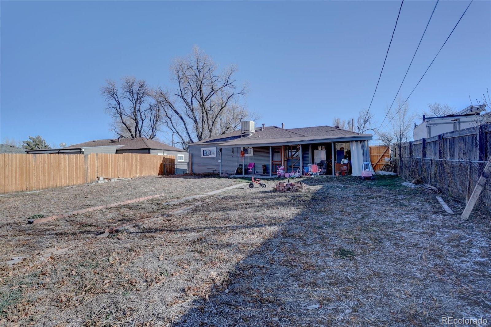 775 Victor Street Aurora, CO 80011 - Photo 19 of 21 a front view of a house with a yard