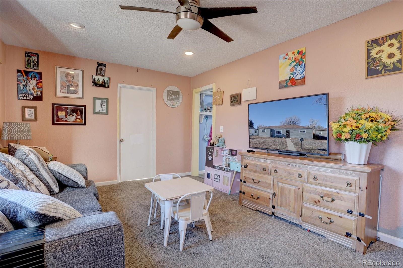 775 Victor Street Aurora, CO 80011 - Photo 2 of 21 a living room with furniture and a dining area