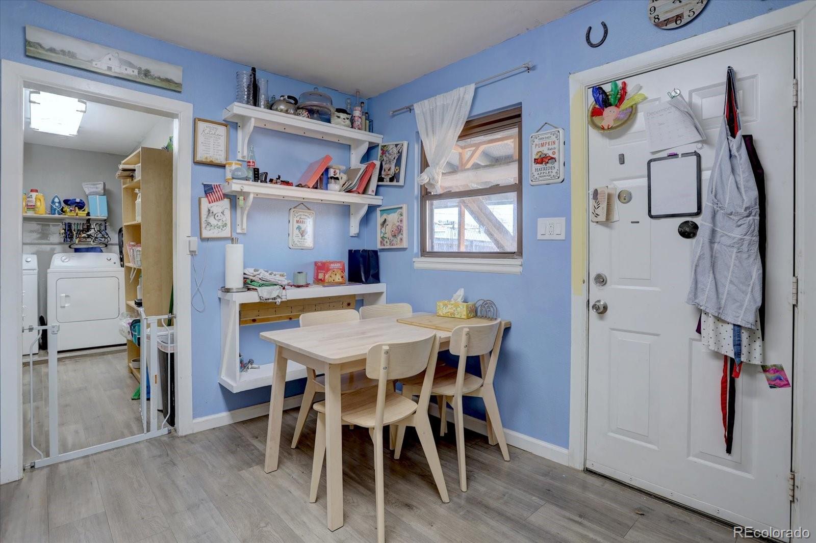 775 Victor Street Aurora, CO 80011 - Photo 8 of 21 a view of a dining room with furniture and wooden floor