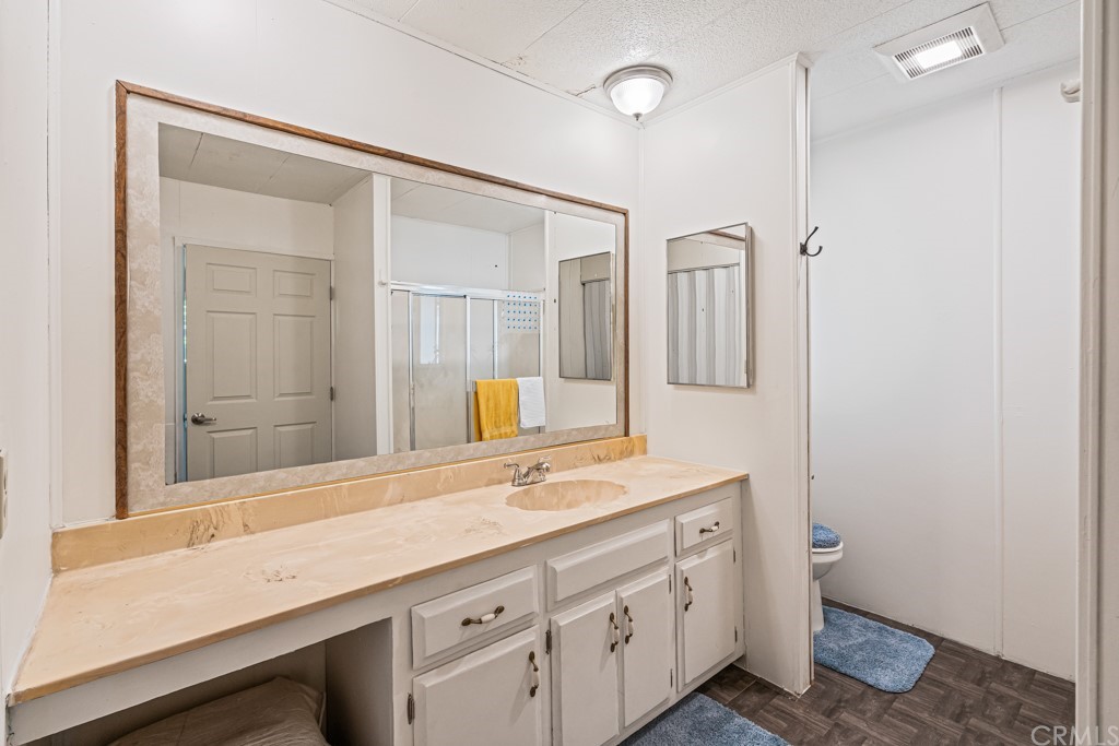 21811 Vera Street, Unit 58 Carson, CA 90745 - Photo 18 of 24 a bathroom with a granite countertop sink mirror and double
