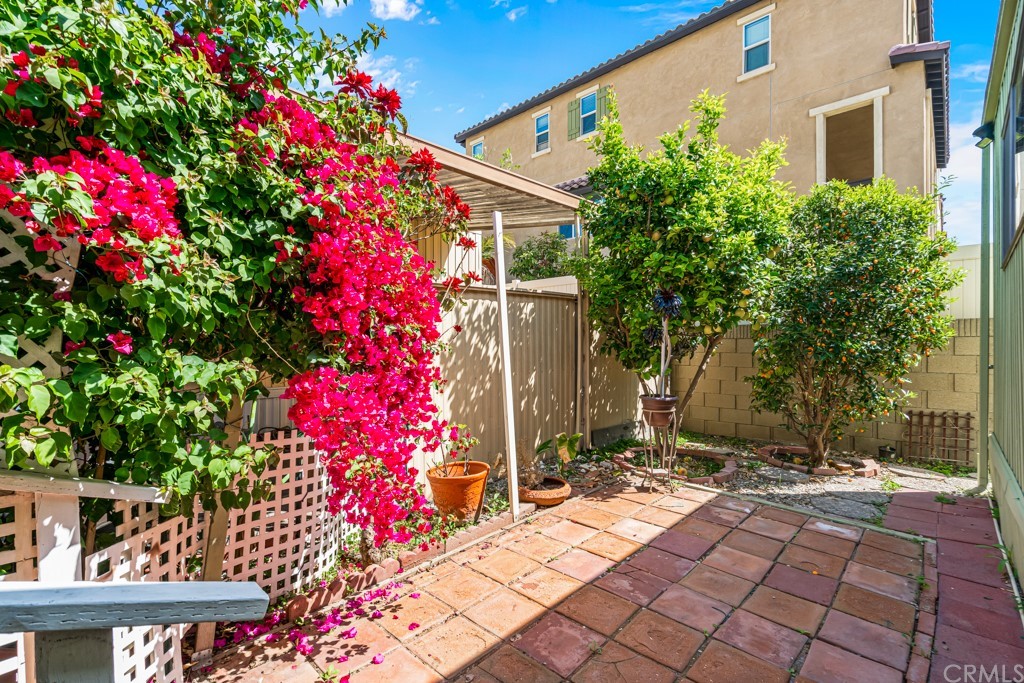 21811 Vera Street, Unit 58 Carson, CA 90745 - Photo 19 of 24 a flower plants with wooden fence