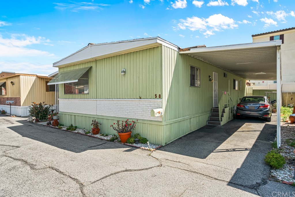 21811 Vera Street, Unit 58 Carson, CA 90745 - Photo 23 of 24 a car parked in front of a house