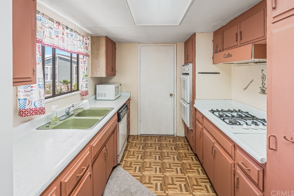 21811 Vera Street, Unit 58 Carson, CA 90745 - Photo 10 of 24 a kitchen with a sink a stove and refrigerator