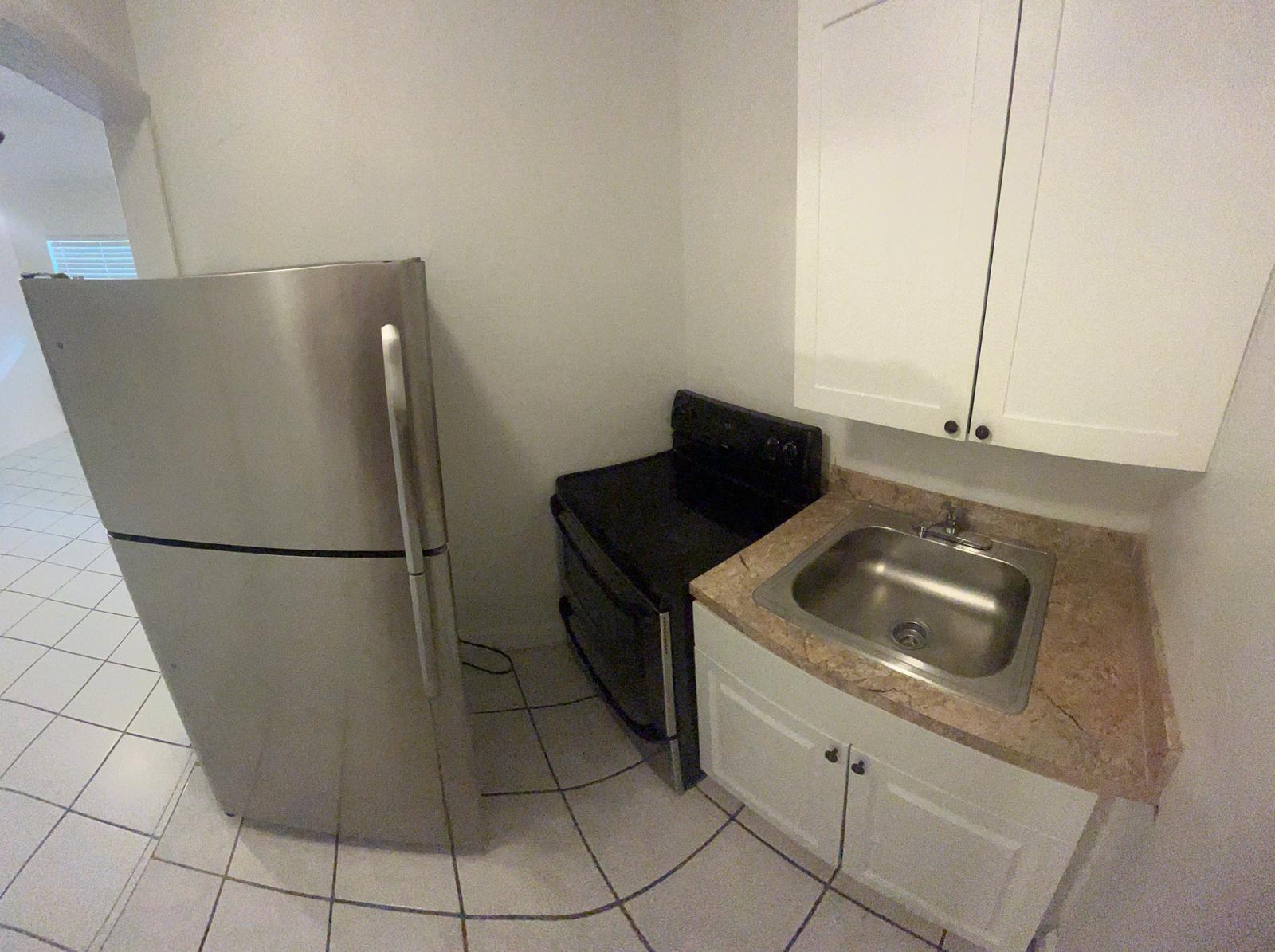 5930 Pierce Street, Unit 3 Hollywood, FL 33021 - Photo 3 of 10 a kitchen with a refrigerator and a sink