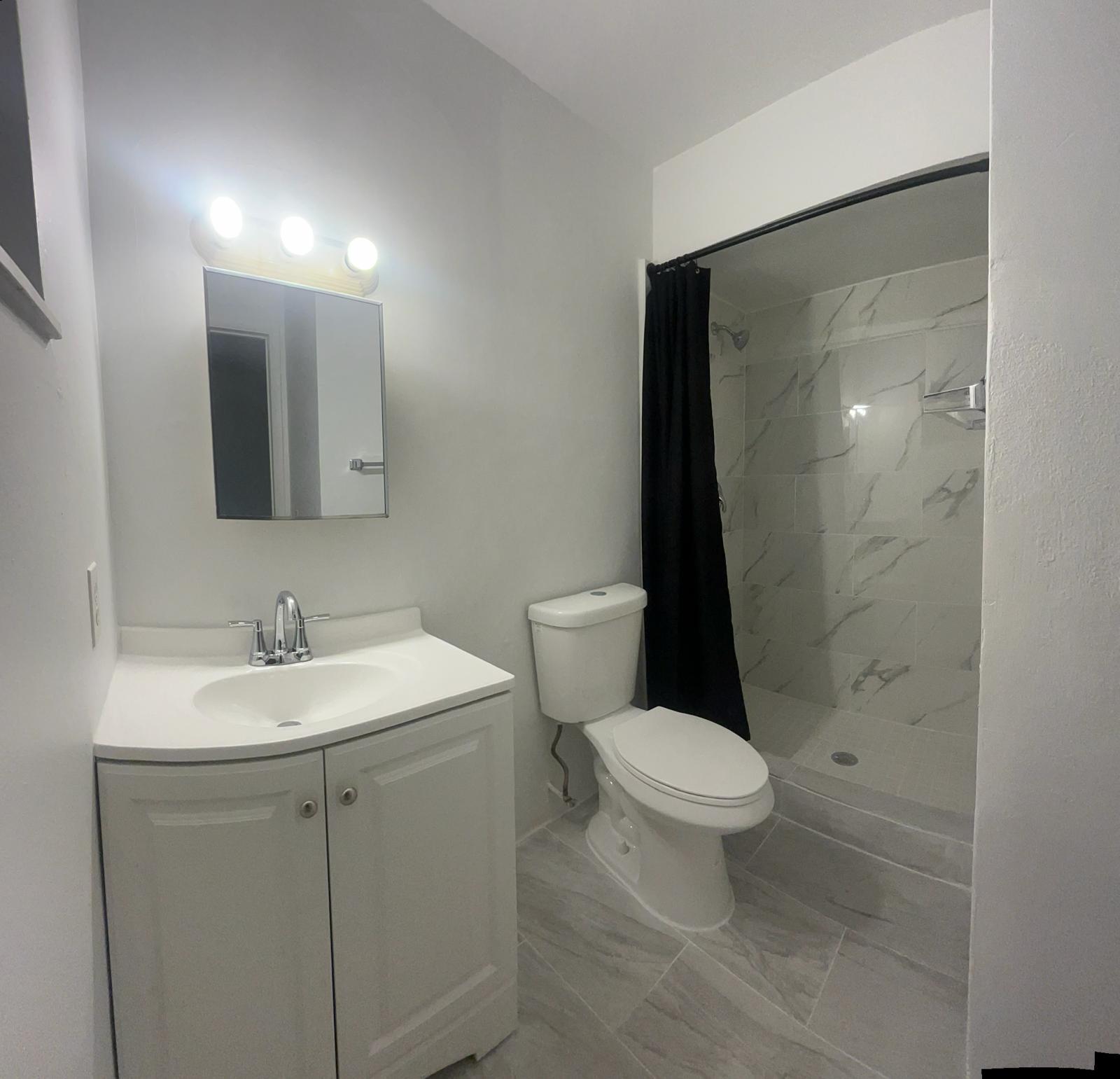 5930 Pierce Street, Unit 3 Hollywood, FL 33021 - Photo 4 of 10 a white toilet sitting next to a bathroom sink