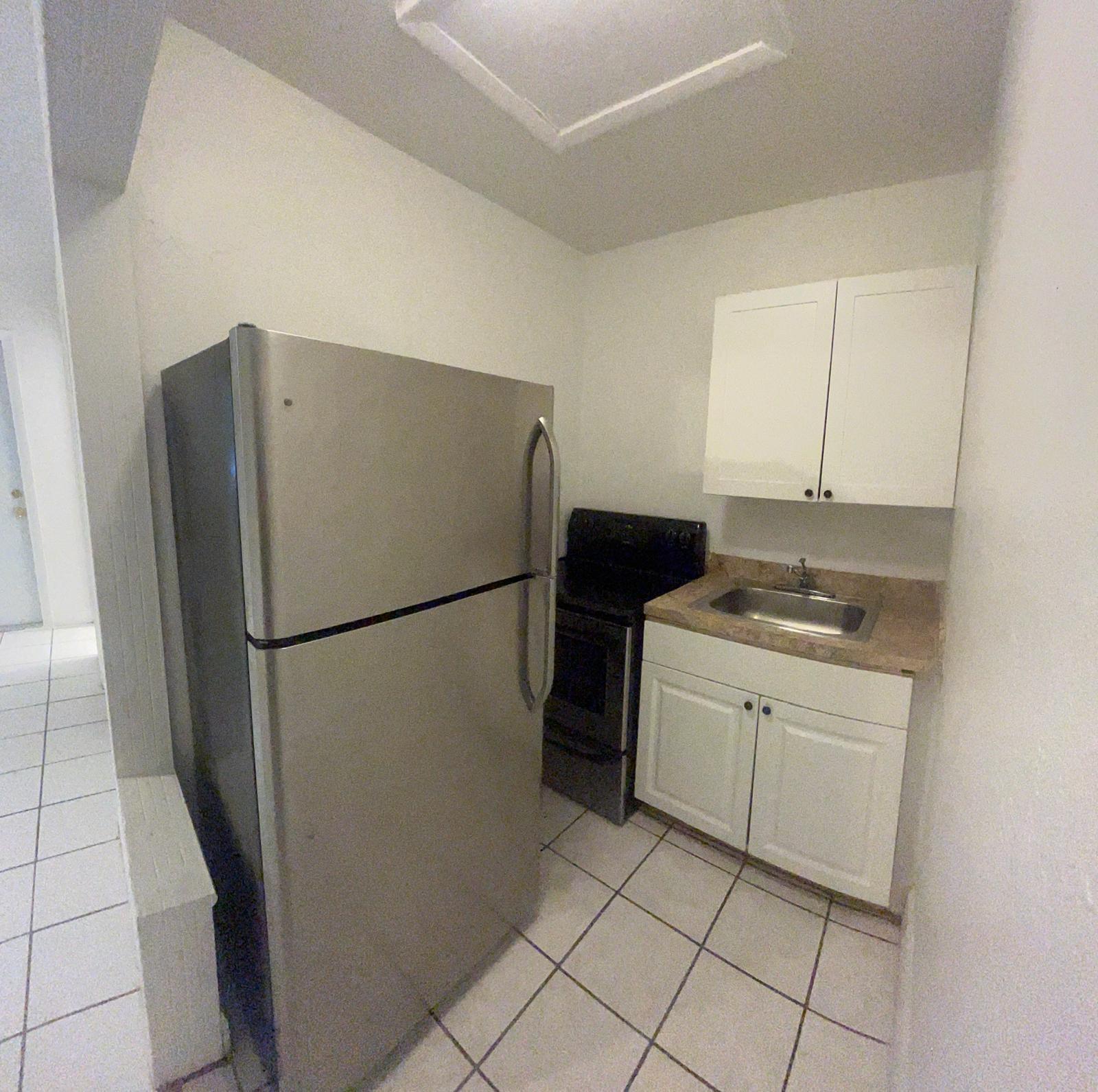 5930 Pierce Street, Unit 3 Hollywood, FL 33021 - Photo 8 of 10 a kitchen with a refrigerator and a stove