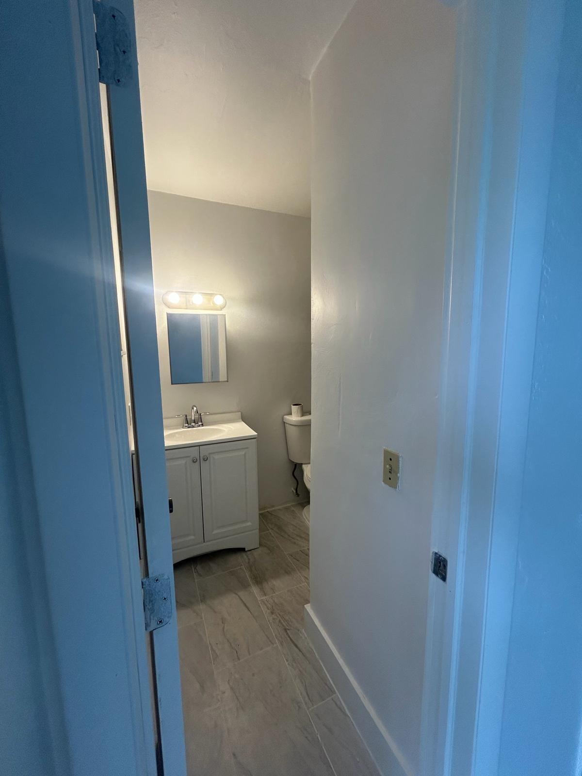 5930 Pierce Street, Unit 3 Hollywood, FL 33021 - Photo 9 of 10 a bathroom with a sink a toilet and mirror