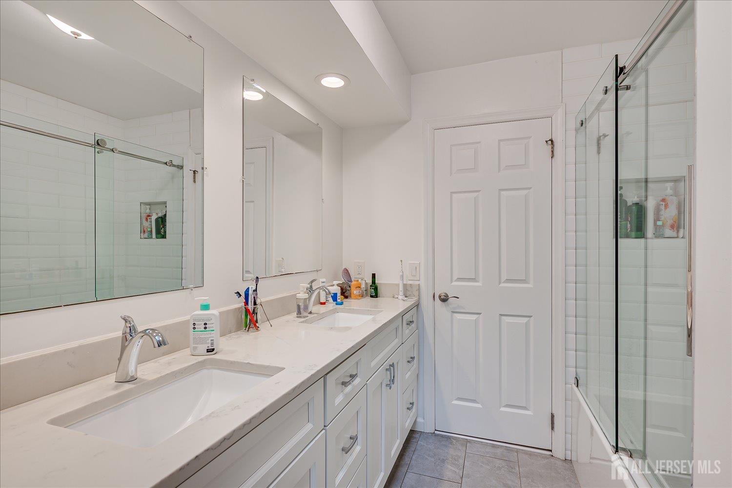 903 Maplecrest Road Edison, NJ 08820 - Photo 18 of 24 a bathroom with double vanity sink and a mirror