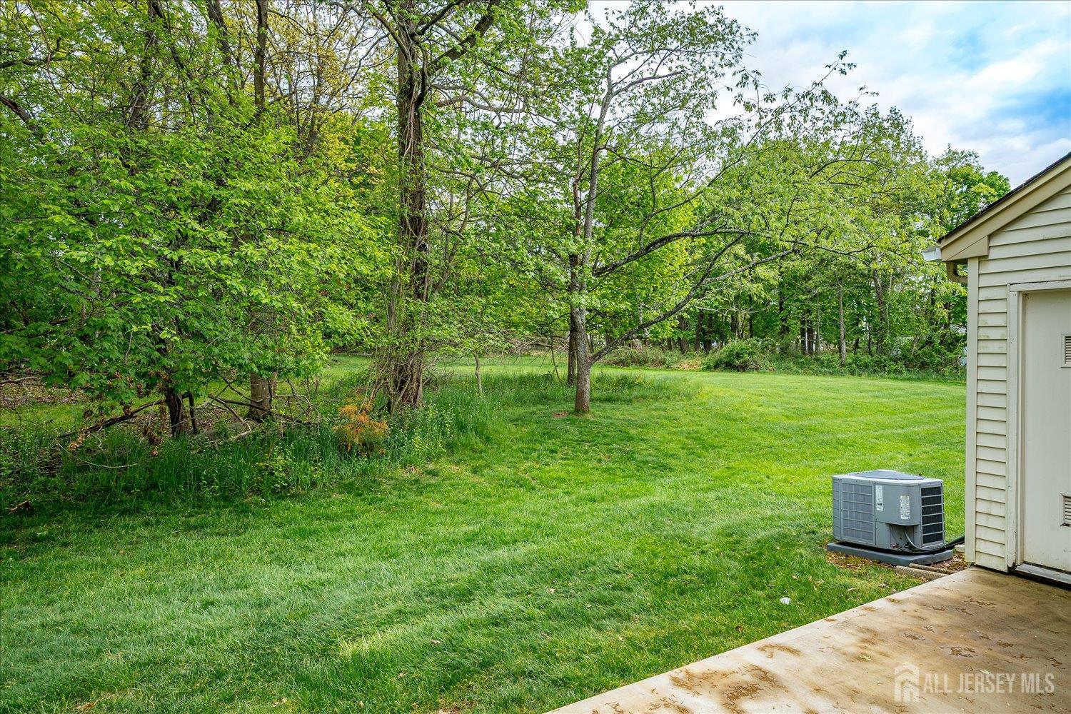 903 Maplecrest Road Edison, NJ 08820 - Photo 23 of 24 a view of a garden with plants and a bench
