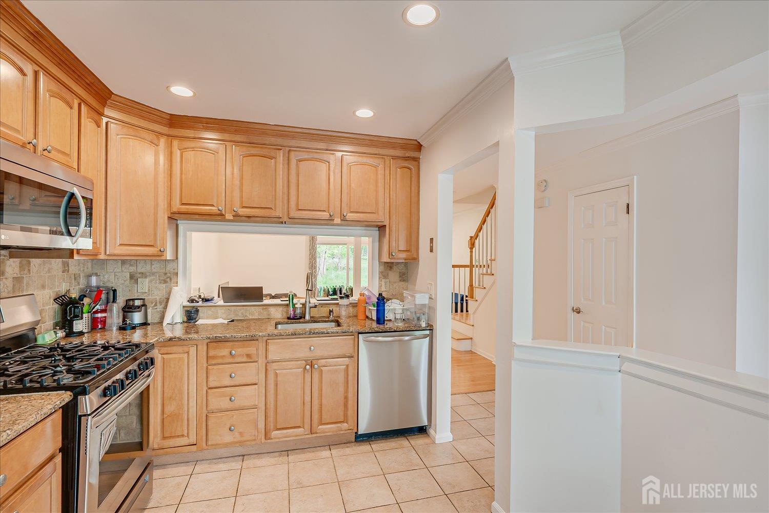 903 Maplecrest Road Edison, NJ 08820 - Photo 4 of 24 a kitchen with stainless steel appliances granite countertop a stove a sink dishwasher and a refrigerator