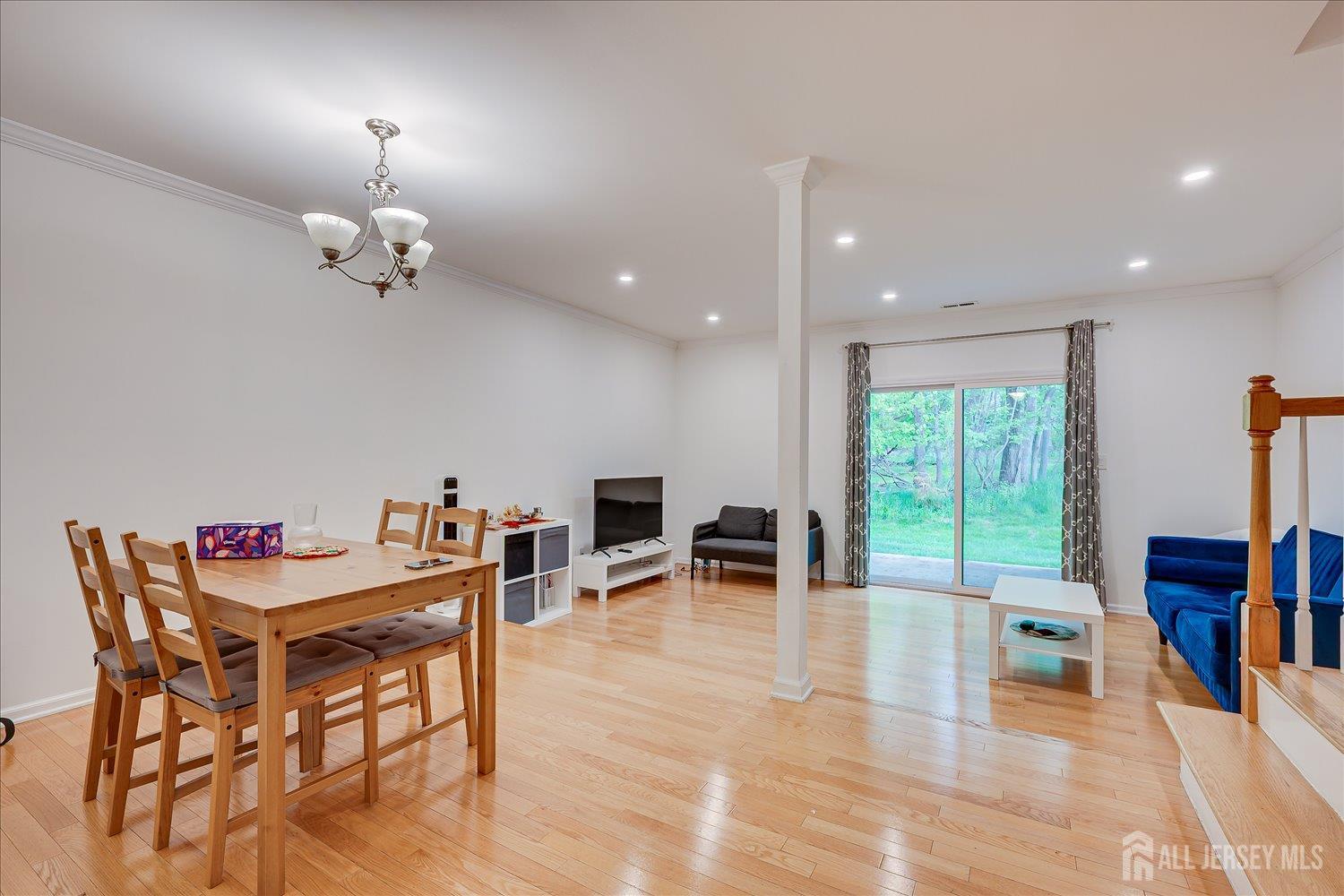 903 Maplecrest Road Edison, NJ 08820 - Photo 6 of 24 a view of a dining room with furniture a chandelier and wooden floor