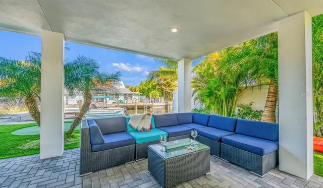 a view of a house with a yard and sitting area