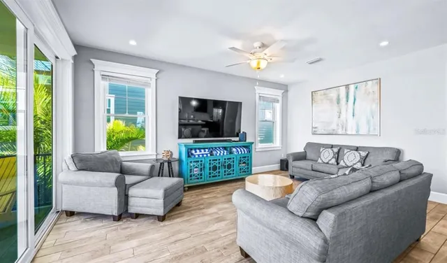 a view of a balcony with chairs and wooden floor