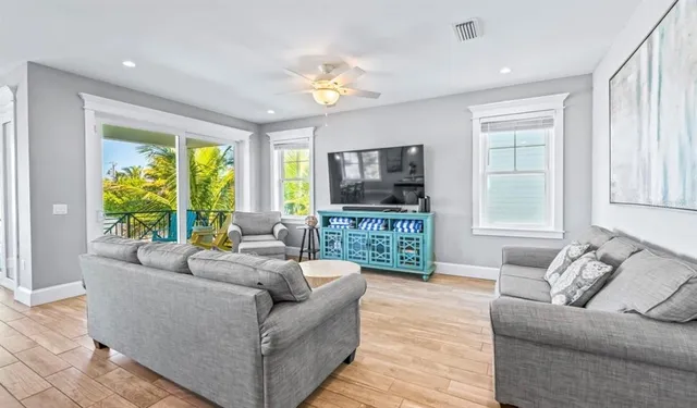 a large kitchen with a stove and a view of living room