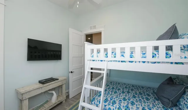 a bedroom with a bed and flat screen tv