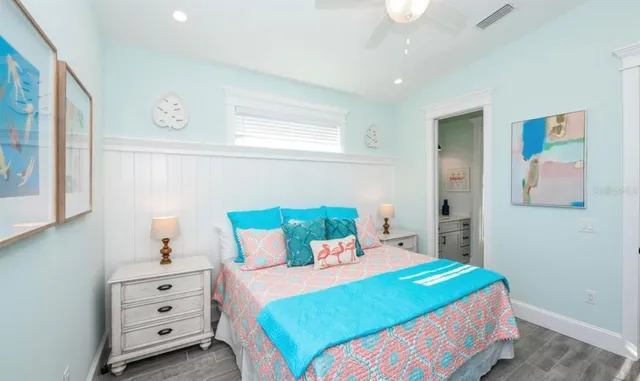 a bedroom with a bed and a painting on the wall