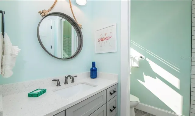 a bathroom with a sink a mirror and a window