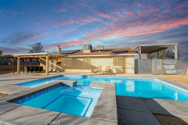 a view of a swimming pool with an outdoor seating