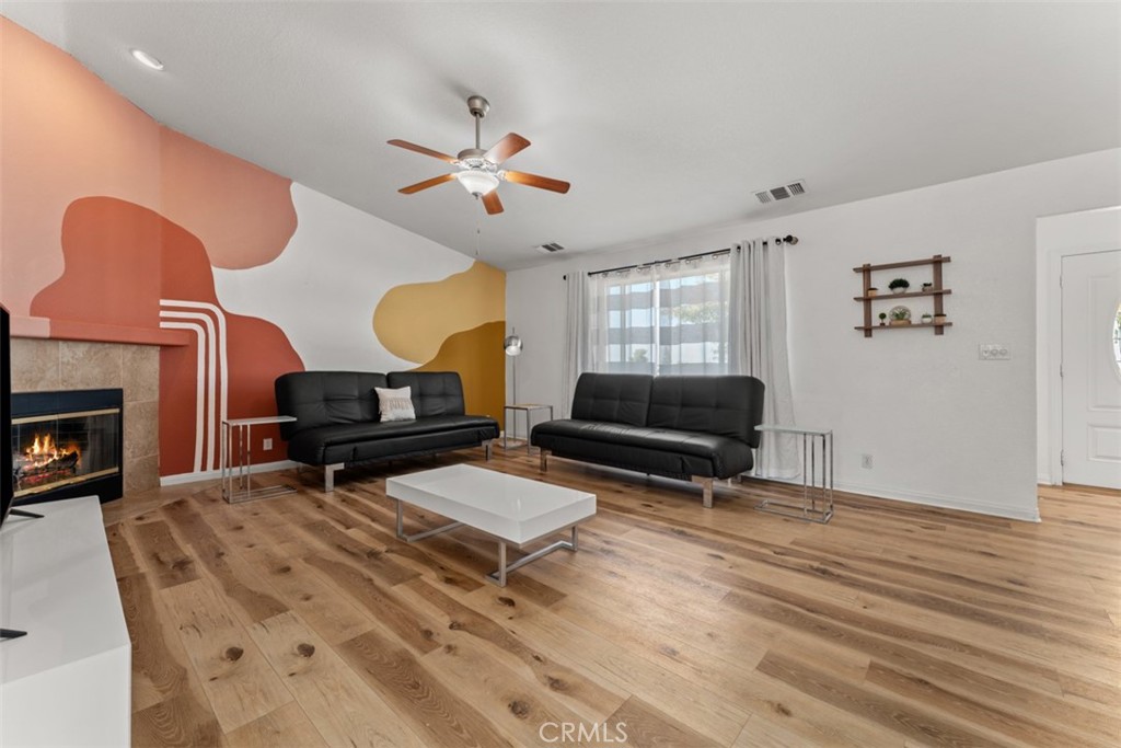 60205 Latham Trail Joshua Tree, CA 92252 - Photo 15 of 38 a living room with furniture a fireplace and a window