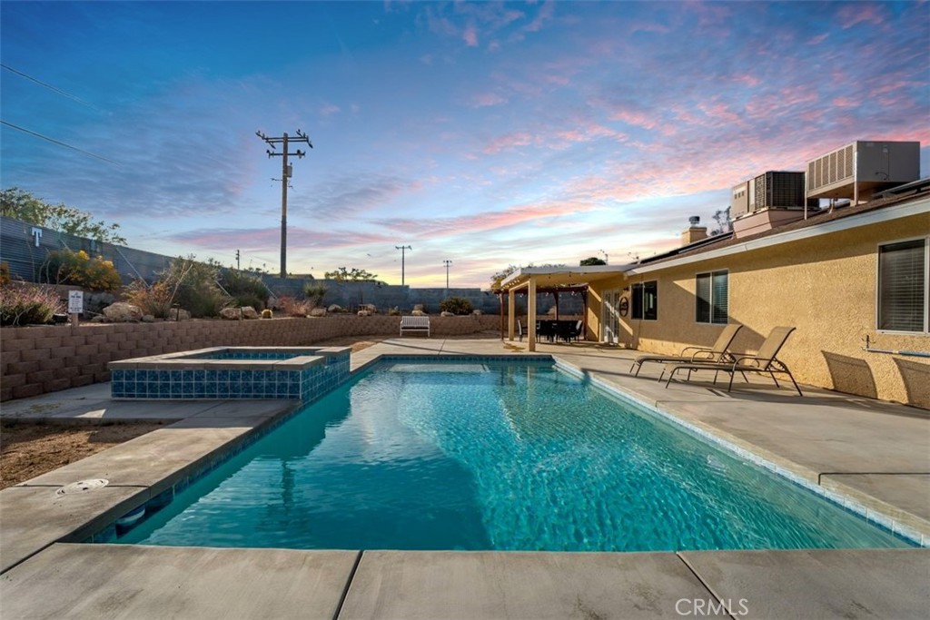 60205 Latham Trail Joshua Tree, CA 92252 - Photo 2 of 38 a view of a swimming pool with a sitting space