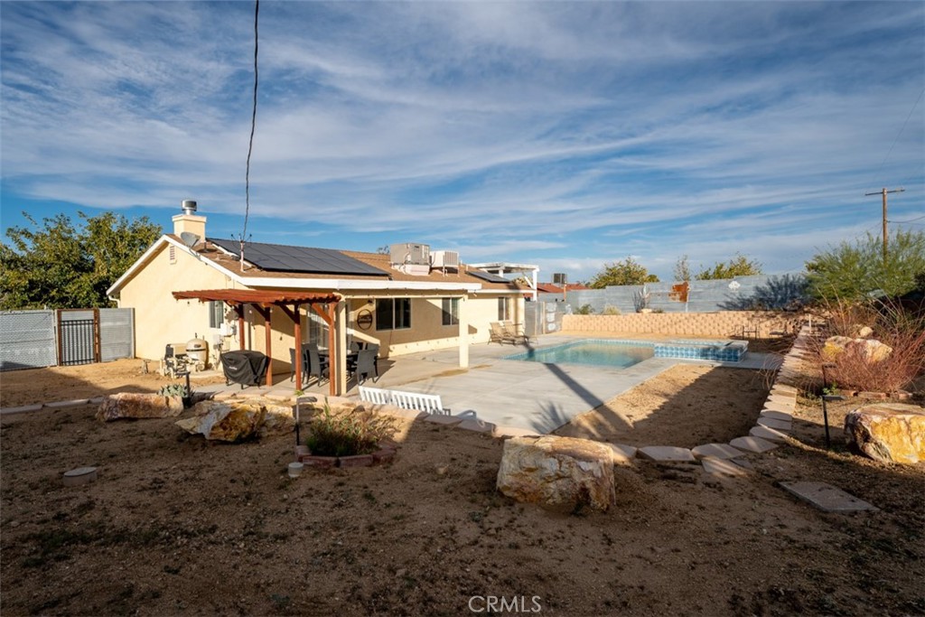60205 Latham Trail Joshua Tree, CA 92252 - Photo 25 of 38 a house view with a backyard space