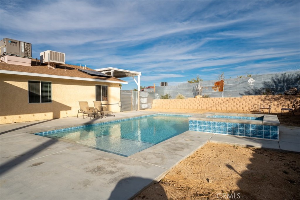 60205 Latham Trail Joshua Tree, CA 92252 - Photo 26 of 38 a view of a house with a backyard