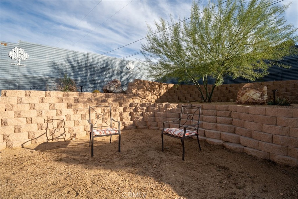 60205 Latham Trail Joshua Tree, CA 92252 - Photo 35 of 38 a backyard of a house with table and chairs