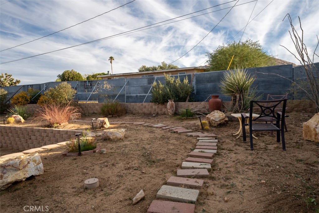 60205 Latham Trail Joshua Tree, CA 92252 - Photo 37 of 38 a view of a backyard with sitting area