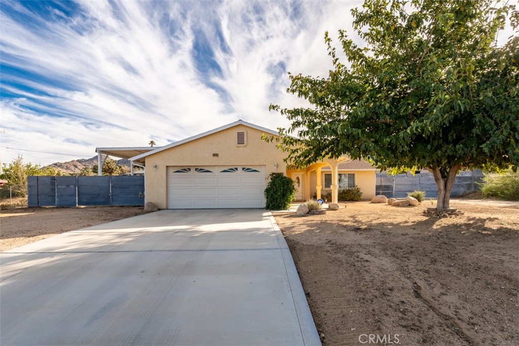 60205 Latham Trail Joshua Tree, CA 92252 - Photo 38 of 38 a front view of a house with a yard and garage