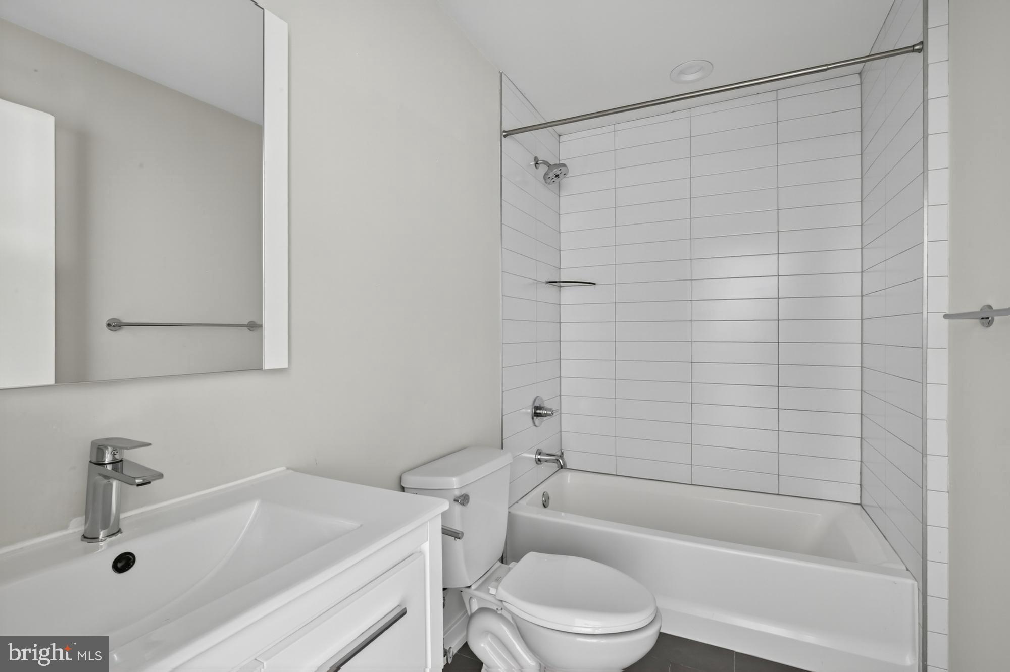 381 Martin Street, Unit 2 Philadelphia, PA 19128 - Photo 11 of 20 a bathroom with a sink a toilet and shower