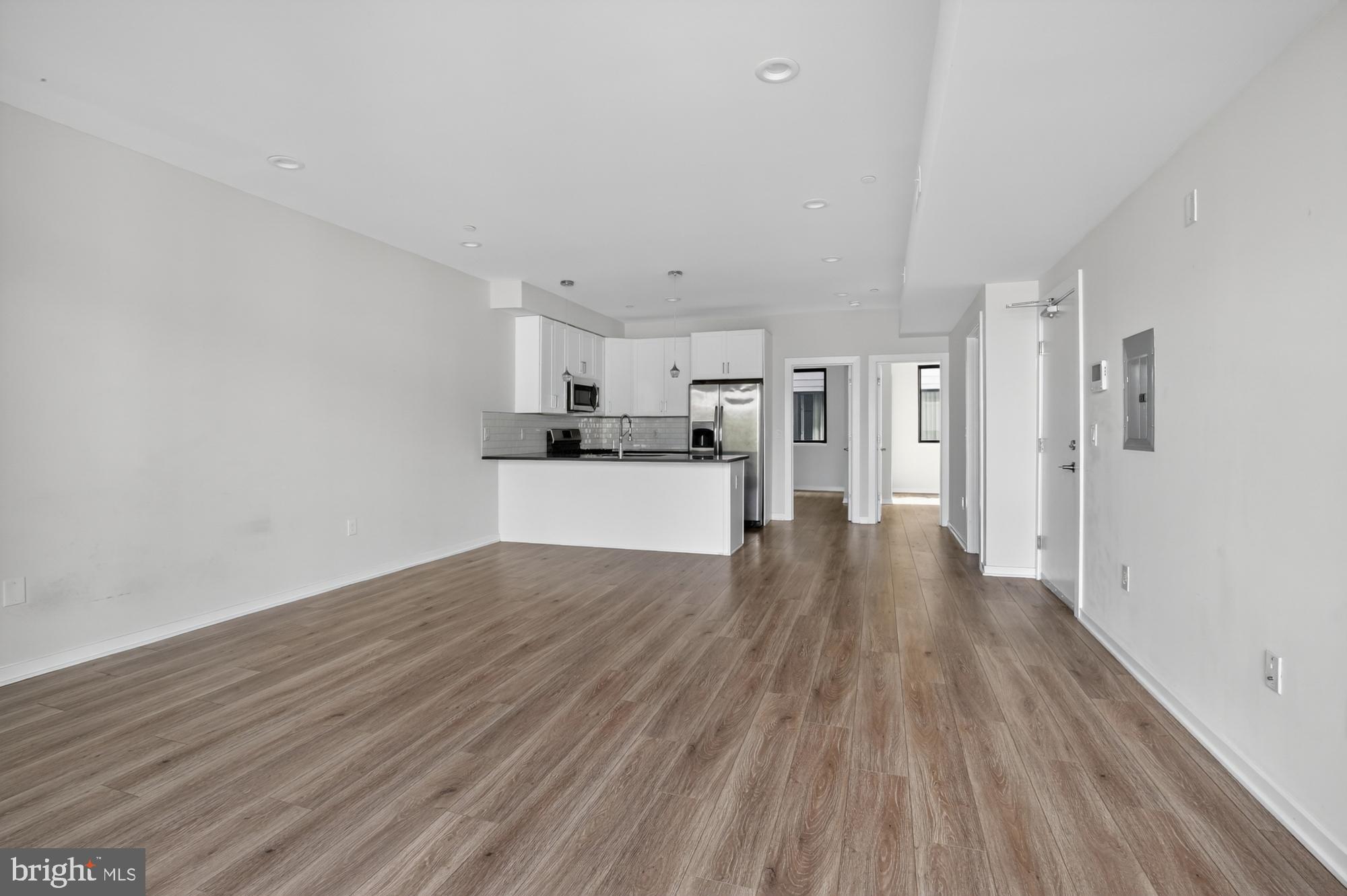 381 Martin Street, Unit 2 Philadelphia, PA 19128 - Photo 8 of 20 a view of a kitchen with wooden floor and electronic appliances