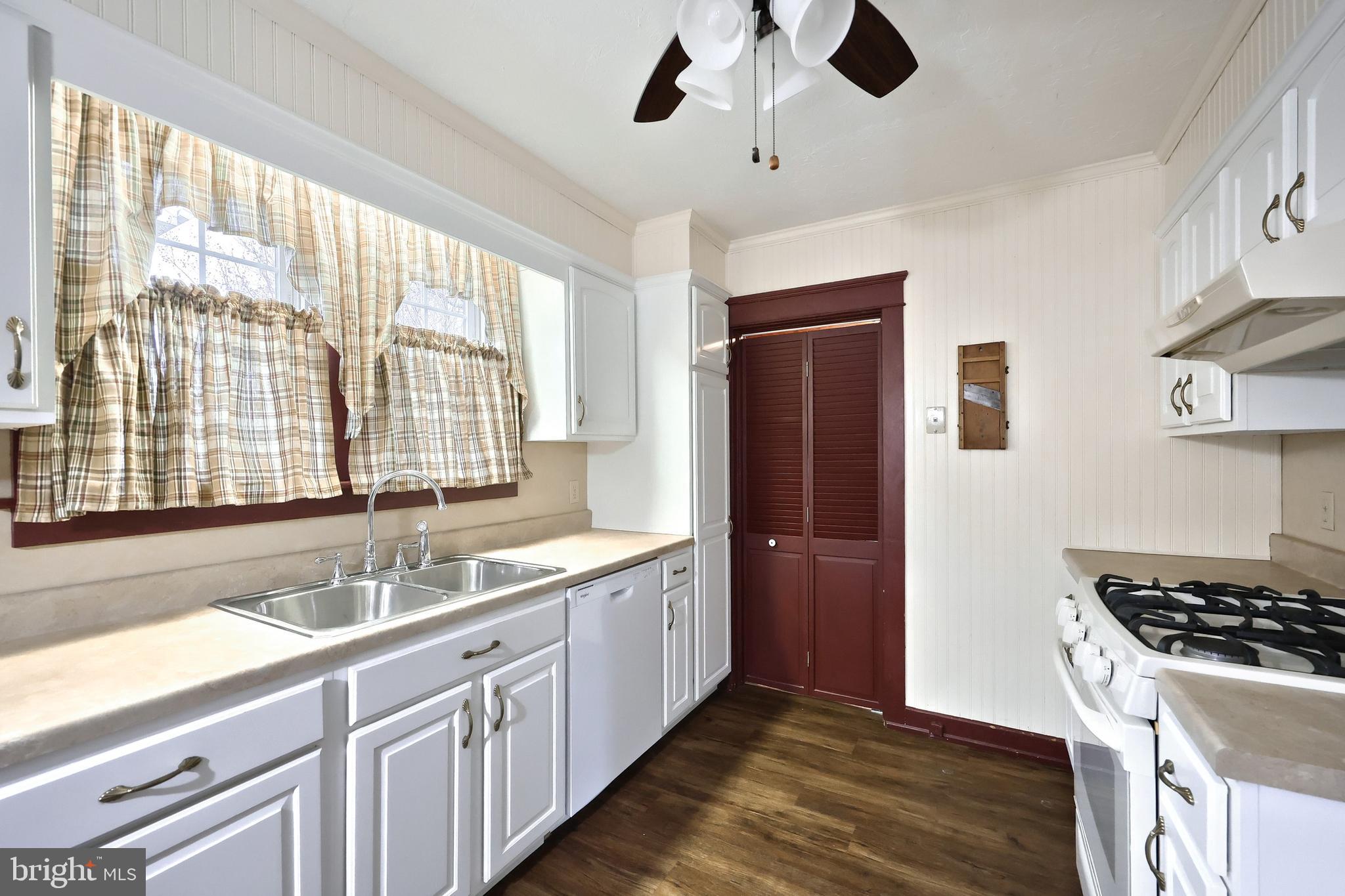99 5th Street Hanover, PA 17331 - Photo 14 of 38 a kitchen with stainless steel appliances granite countertop a sink and wooden floors